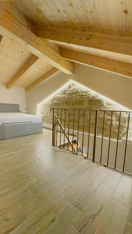 a room with a bed and a wooden ceiling at Ca Rolina in Camagna Monferrato