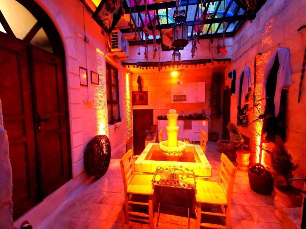 a room with a table and chairs in a building at Emka historic biutuque stone house in Urfa