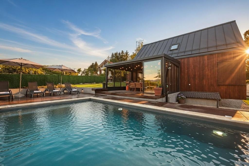 a swimming pool in front of a house at Casa Luna in Ravna Gora