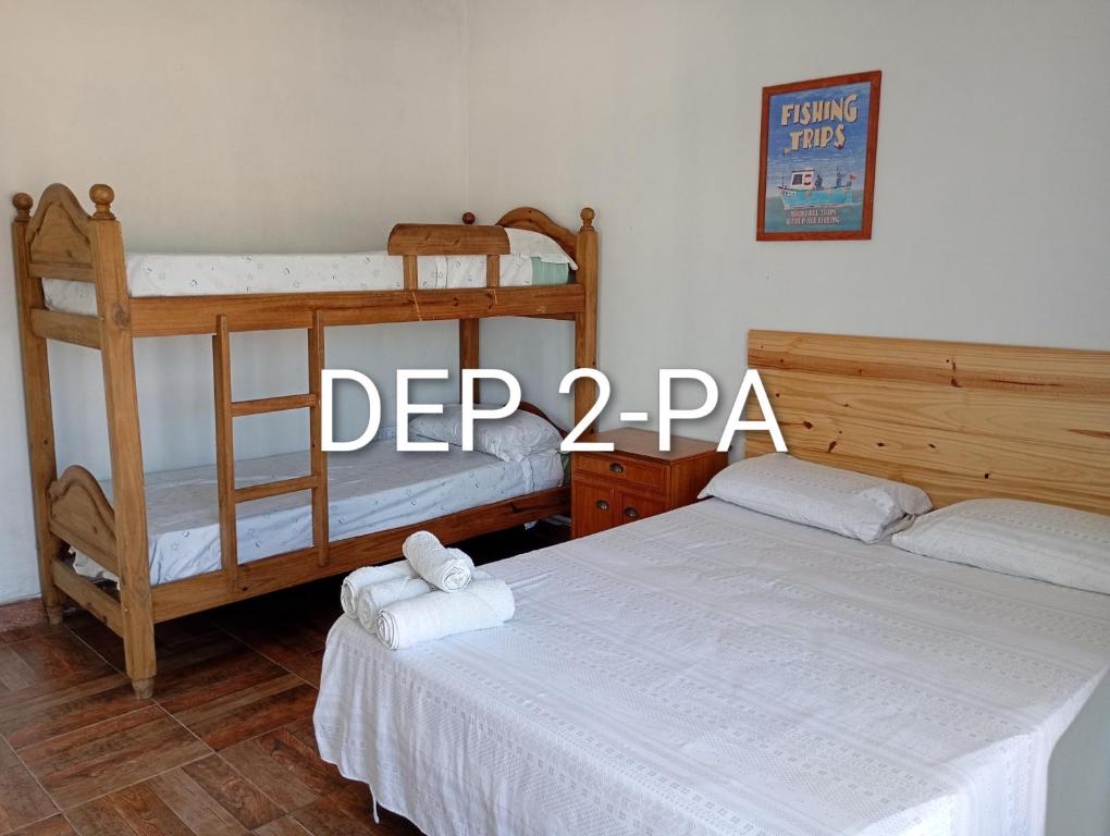 a bedroom with two bunk beds with towels at Alquituc Escobar in Belén de Escobar