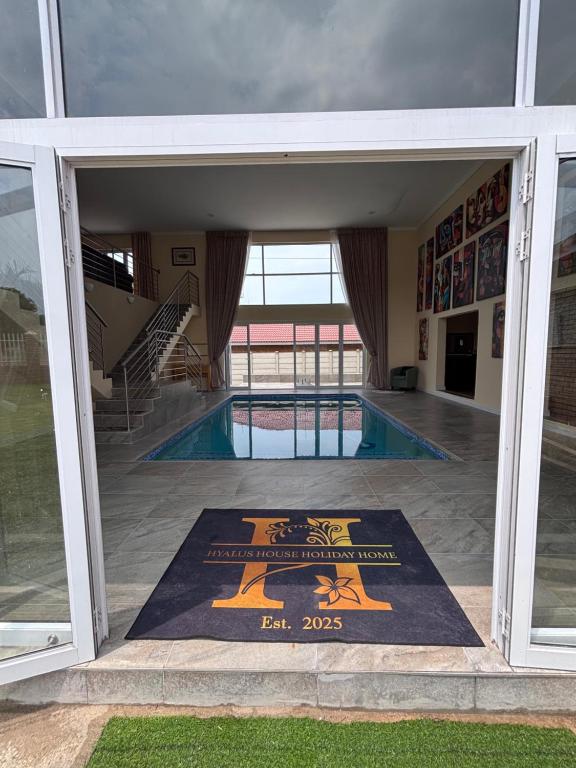a swimming pool with a mat in the entrance to a building at Hyalus House in Vaal Marina