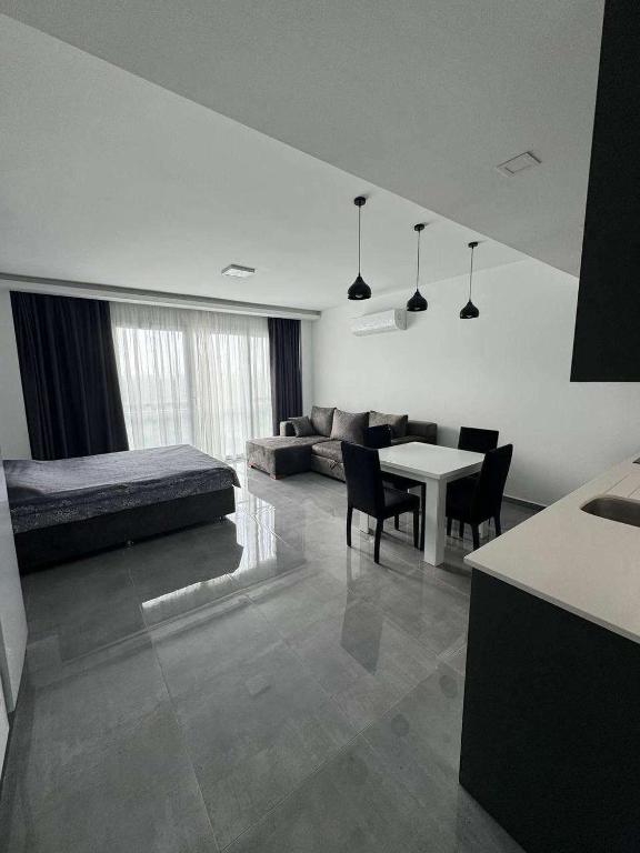 a living room with a bed and a table at CoyrtYard Longbeach Bölgesi İskele Mersin via 10 Cyprus 99850 TRNC Iskele in Iskele
