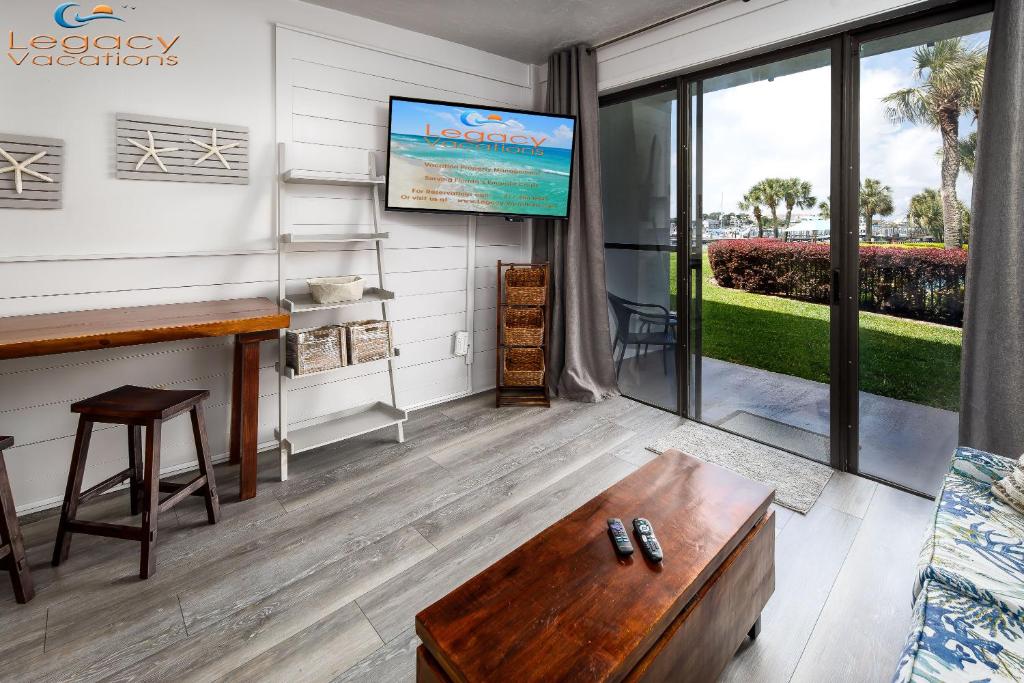 a living room with a tv and a couch at Pirates Bay A108 in Fort Walton Beach