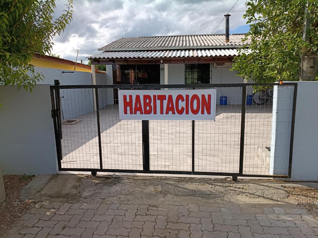 a sign on a gate in front of a house at casa aluguel in Pântano Grande