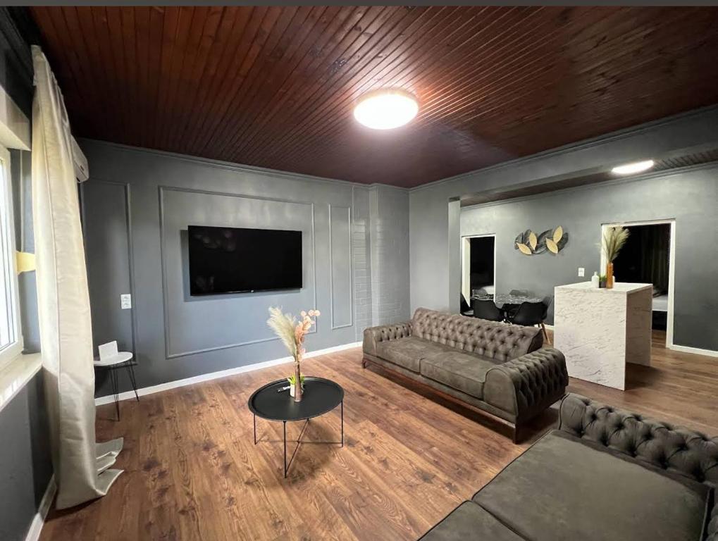 a living room with a couch and a tv at Villa Luxury Crystal center in Bihać