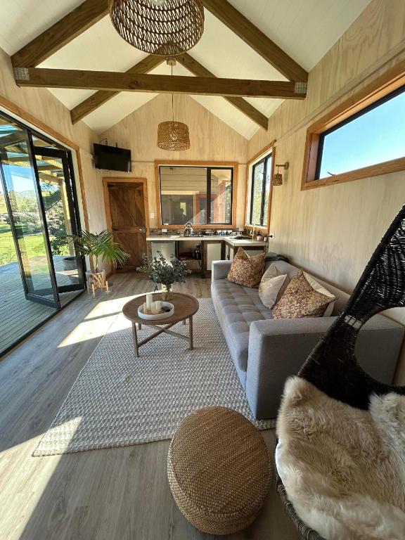 a living room with a couch and a table at Mountain Range Guesthouse in Dovedale