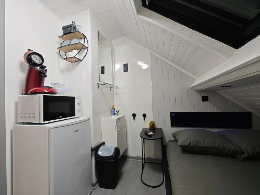 a small bedroom with a bed and a microwave at Budget-Room 2p in Ostend