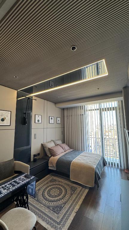 a bedroom with a large bed in a room at Premium Smart Studio with River View in Tbilisi City
