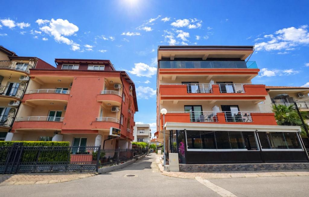 two tall buildings next to each other on a street at Villa & Apartments Antigona in Ohrid