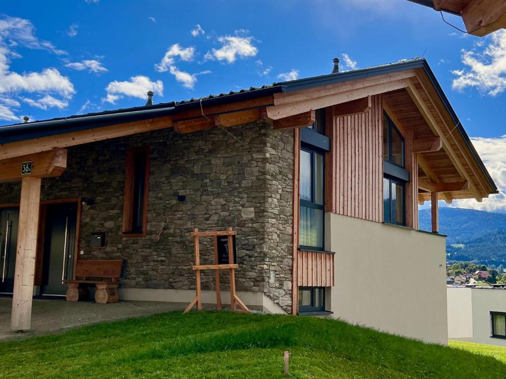 a house with a wooden ladder in front of it at Chalet Kolibri in Sankt Lambrecht