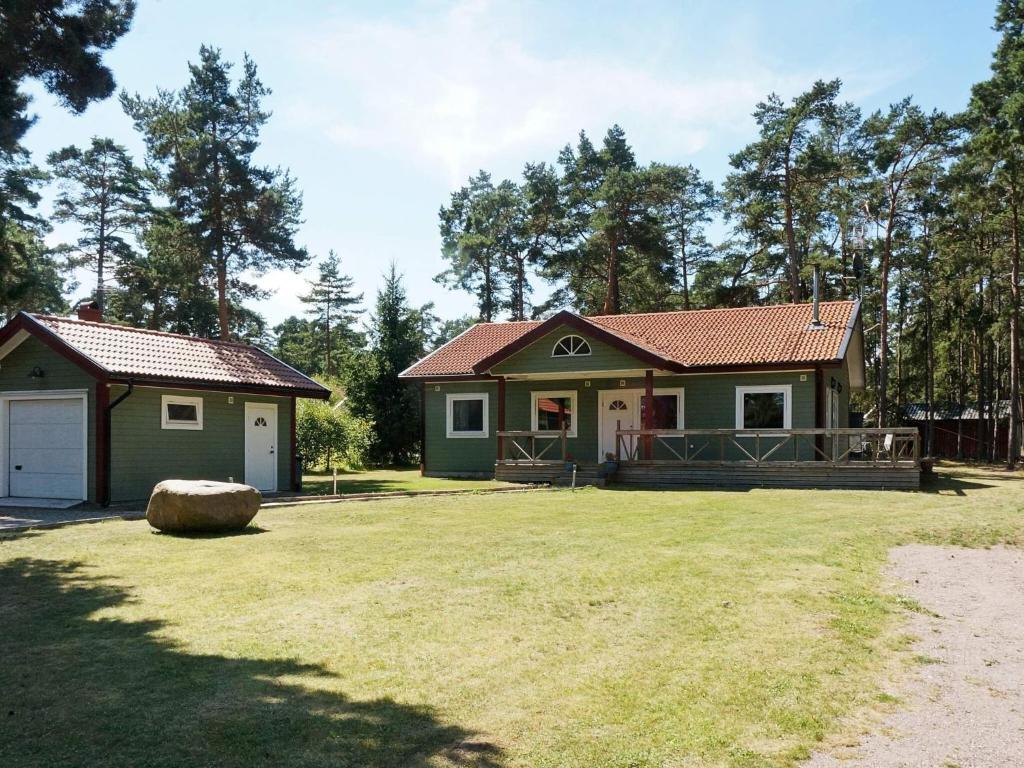a small green house with a large yard at 8 person holiday home in Mönsterås in Mönsterås