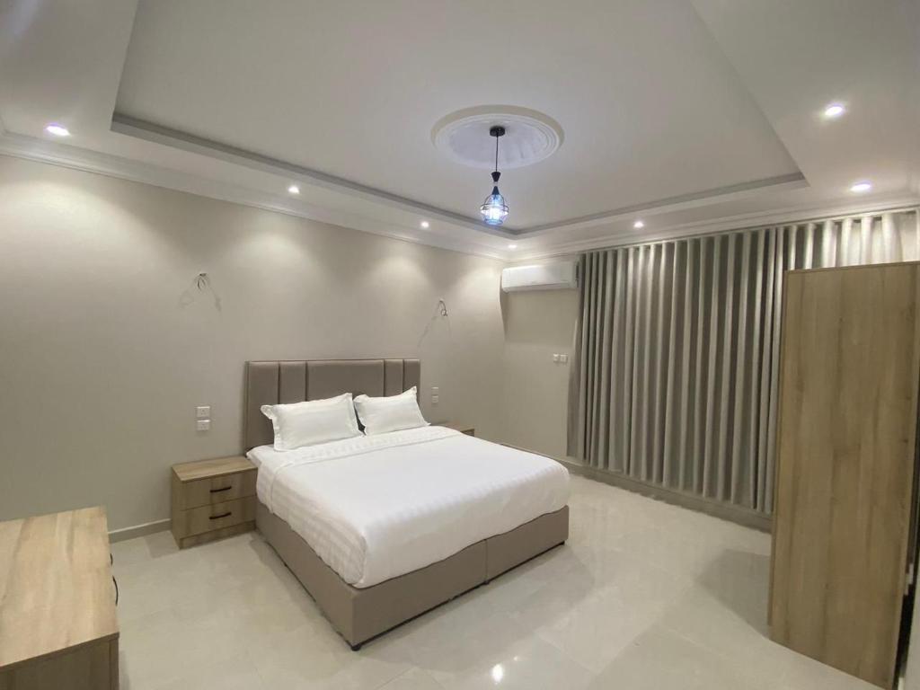 a bedroom with a white bed and a window at مساكن اركان in Quai