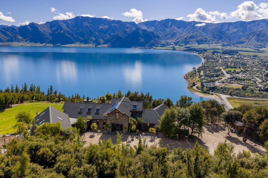 an aerial view of a house on a hill next to a lake at Lake Hawea View in Albert Town