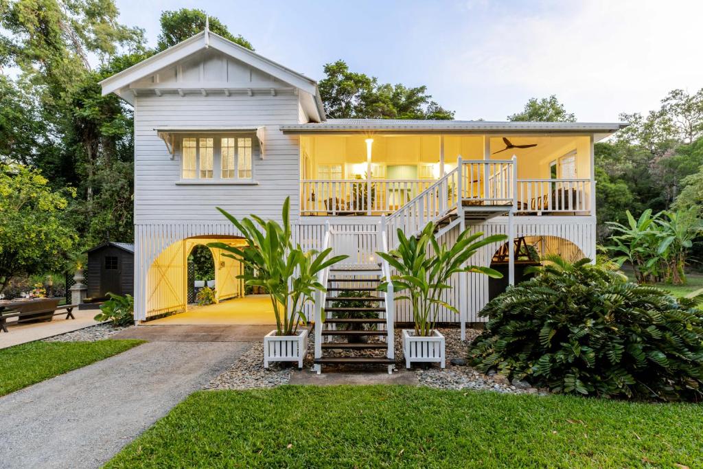 a house with a staircase leading up to it at Charming Queenslander surrounded by Rainforest in Port Douglas