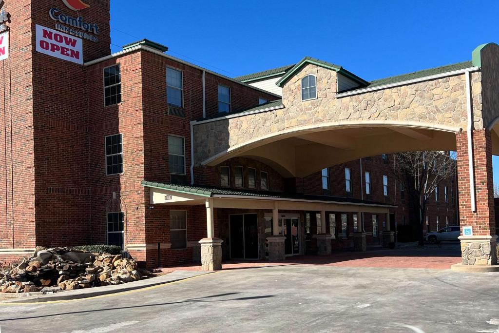 a brick building with an archway in front of it at Comfort Inn & Suites in Lubbock