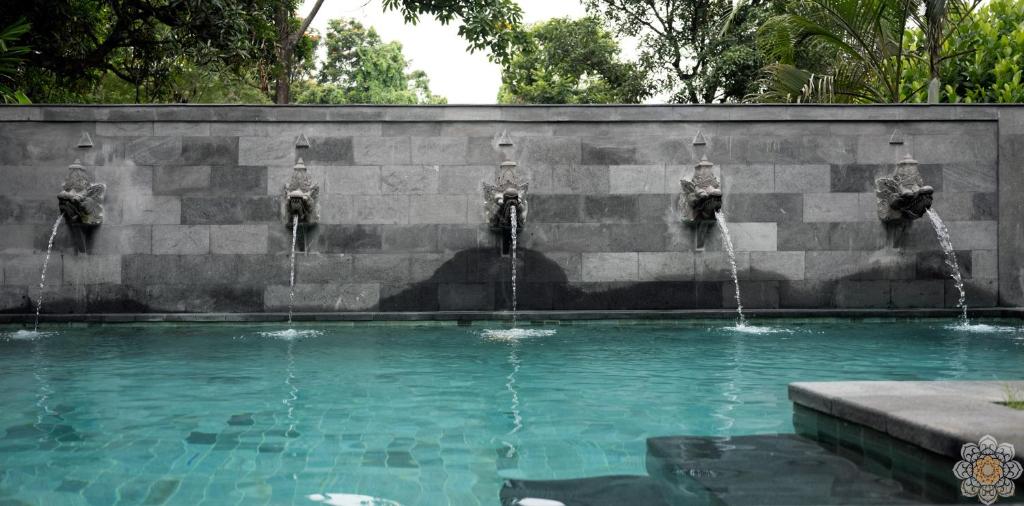 a fountain with water coming out of it at Sananda Aryani in Lovina