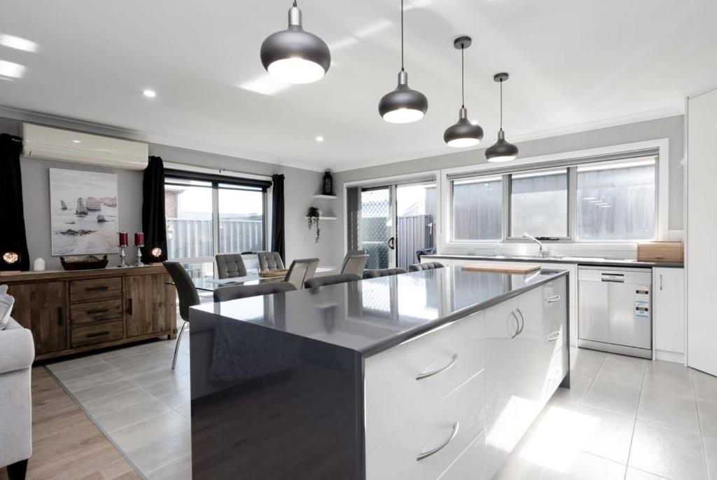 a kitchen with a large island in the middle at Happy Tails Devonport in Devonport