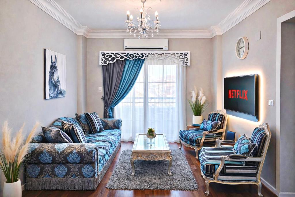 a living room with two couches and a table at Arabella Residence 2BR - New Cairo Luxury Stay in Cairo