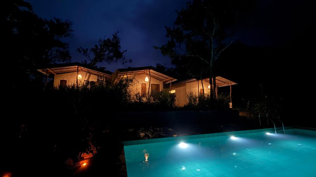 a house with a swimming pool at night at Three Tree Villa By Habarana in Habarana