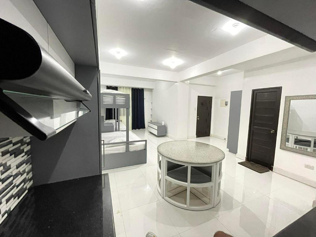 a kitchen with a table in the middle of a room at Host Homes RM201 Independencia St in San Fernando