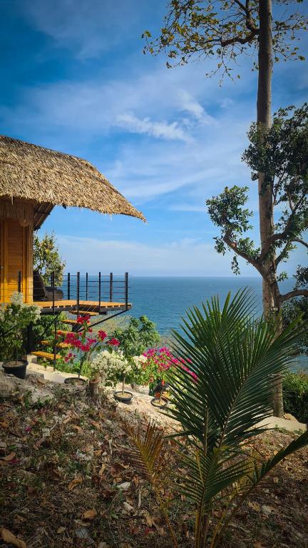 a resort with a view of the ocean at Balay Mariposa in Langagan