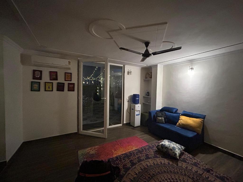 a living room with a bed and a couch at Gurgaon 21 Tonic & Twinkle in Gurgaon