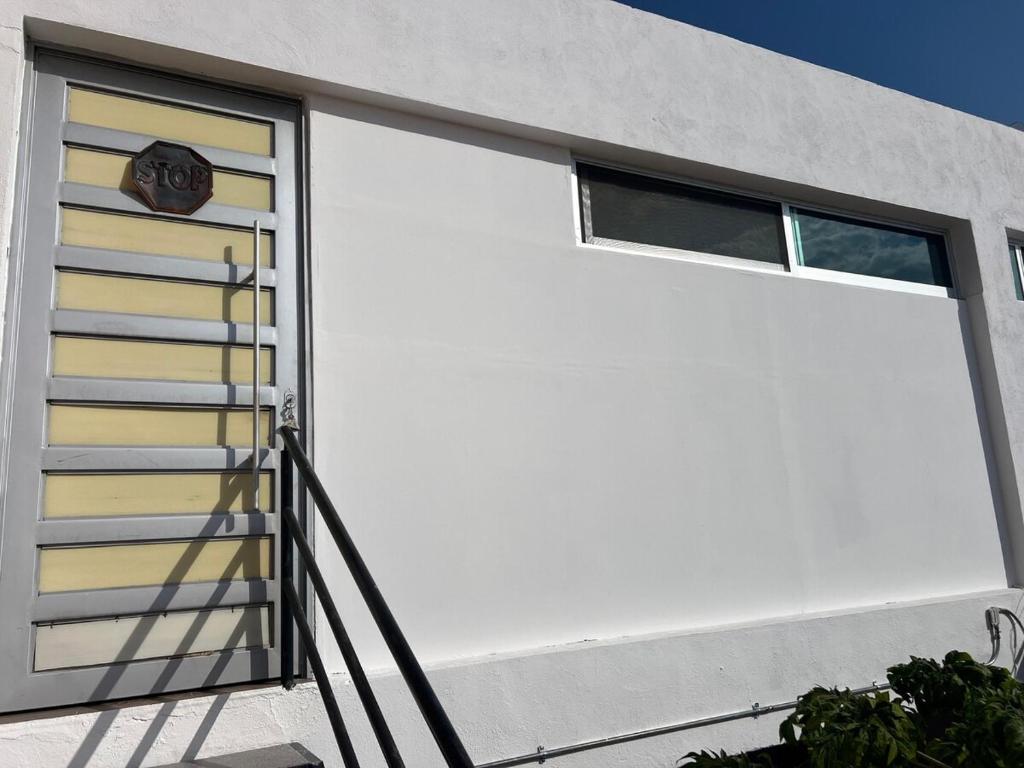 a white garage door on a house at comfortable and nice loft, great location in Aguascalientes