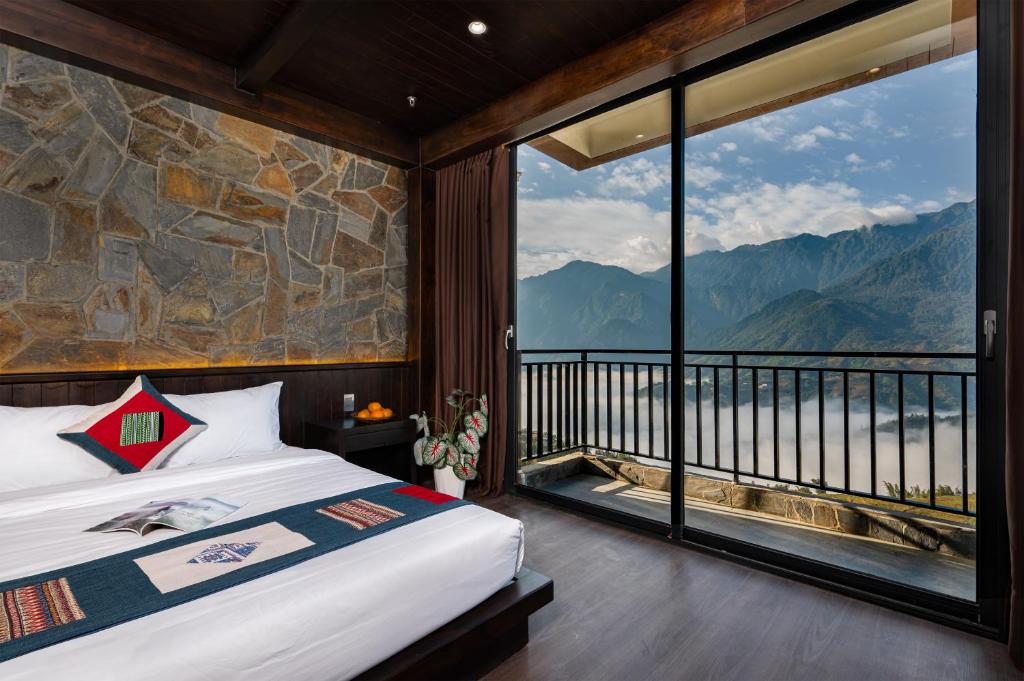 a bedroom with a bed and a large window at TIME Restaurant & Homestay Sa Pa in Sapa