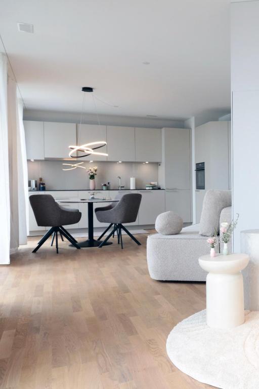 a kitchen and living room with a table and chairs at Laya Living Lucerne - Kriens in Lucerne