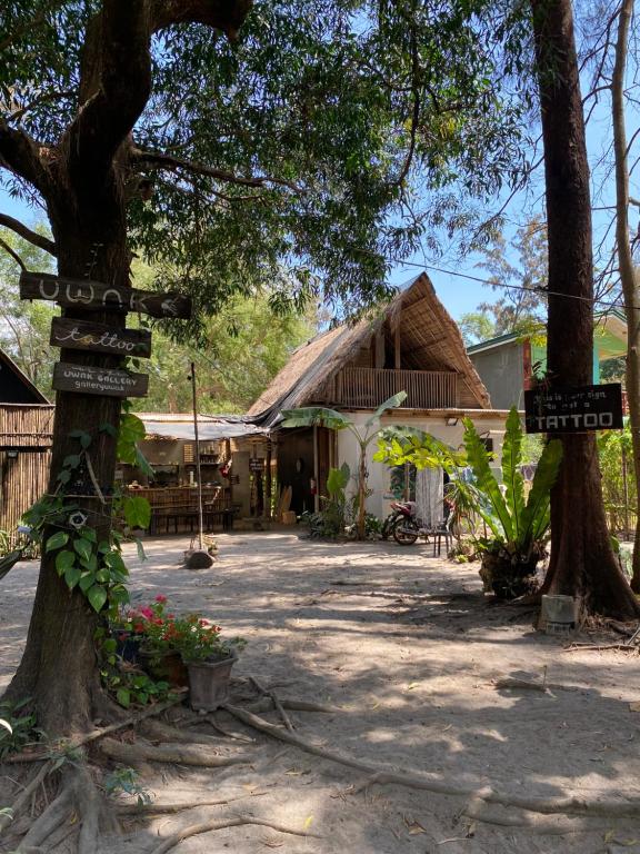 a sign in front of a building with a thatch roof at Uwak Gallery in Zambales