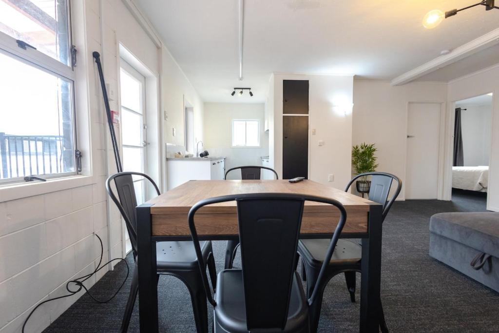 a dining room with a table and chairs in a room at Clock Tower Accommodation in Hokitika