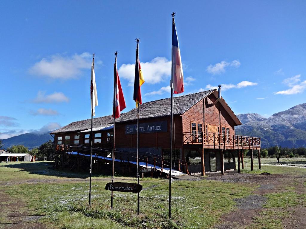 a building with flags in front of it at Eco Hotel Antuco in Antuco