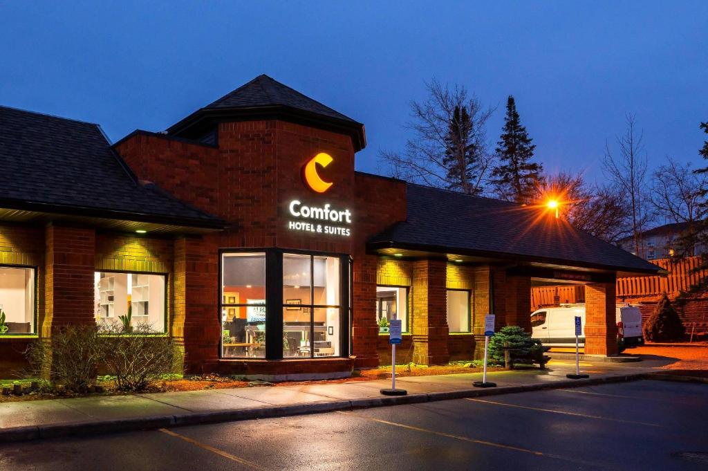 a building with a sign on the side of a street at Comfort Hotel & Suites in Peterborough