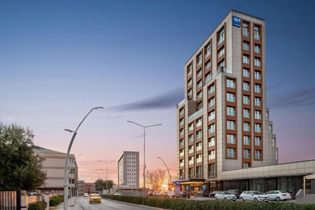 a tall building on a city street with cars parked at Tryp by Wyndham Istanbul Topkapi in Istanbul
