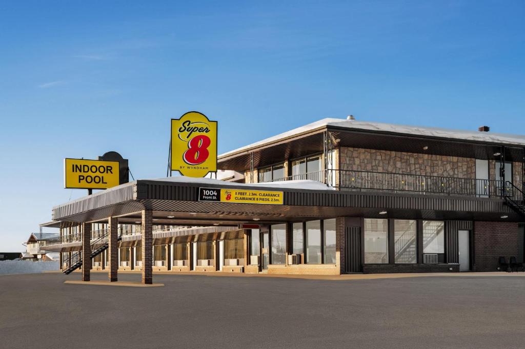 a building with a sign on the side of it at Super 8 by Wyndham Hearst ON in Hearst