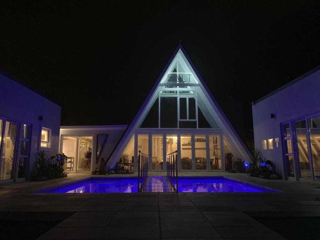 a house with a swimming pool at night at Salt Boutique Guest House in Bloubergstrand