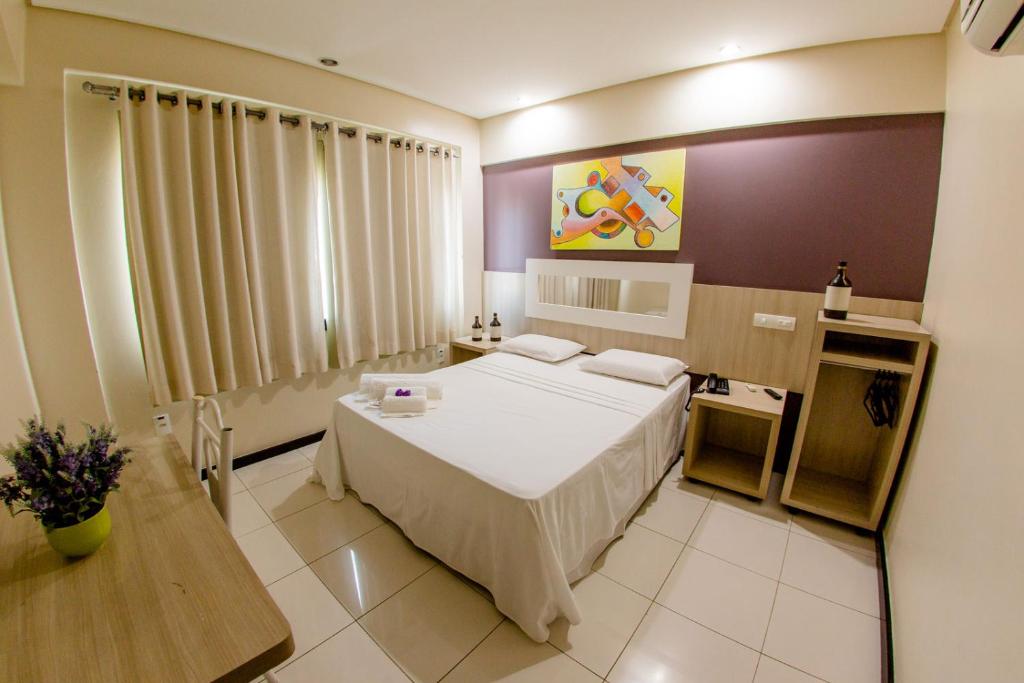 Postel nebo postele na pokoji v ubytování Eunapolis Plaza Hotel