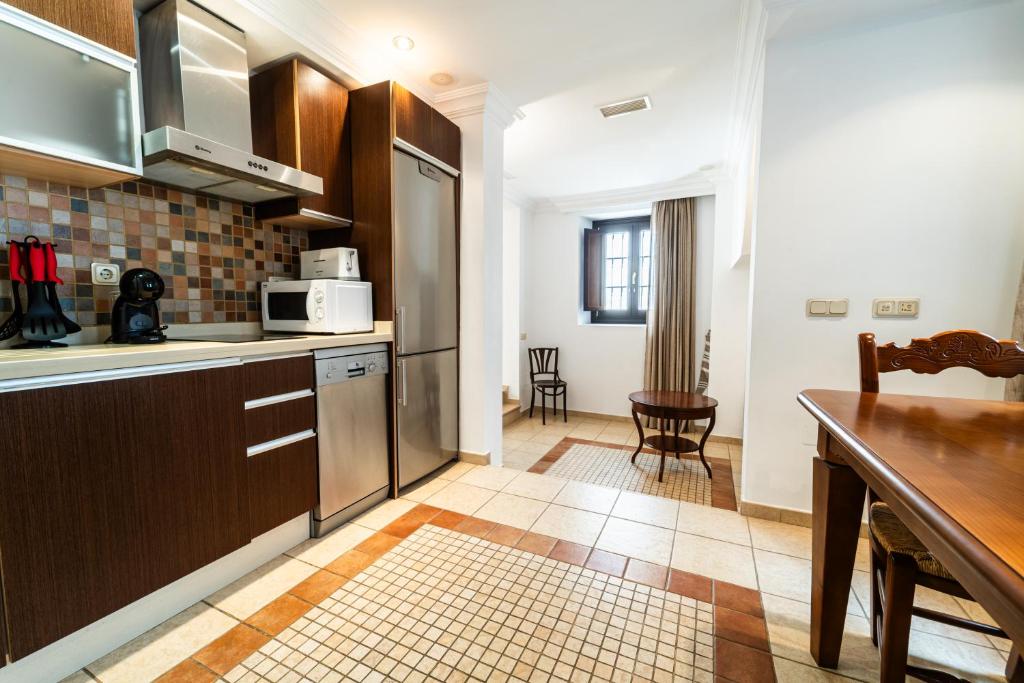 a kitchen with a counter and a table in a room at GAV Ciudad in Ronda