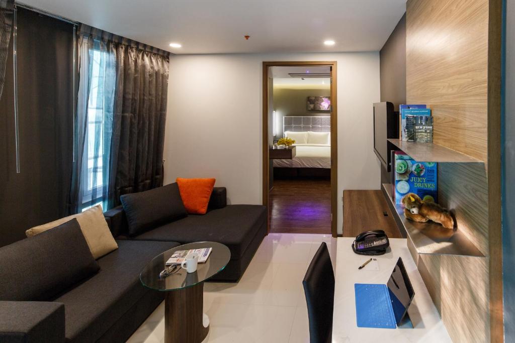 A furnished lounge-dining area with a corner sofa and worktable.