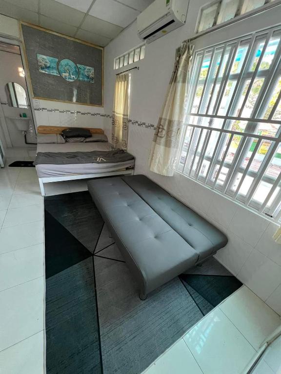 a room with two beds and a window at Homestay 14 Tôn Đức Thắng in Phan Thiet