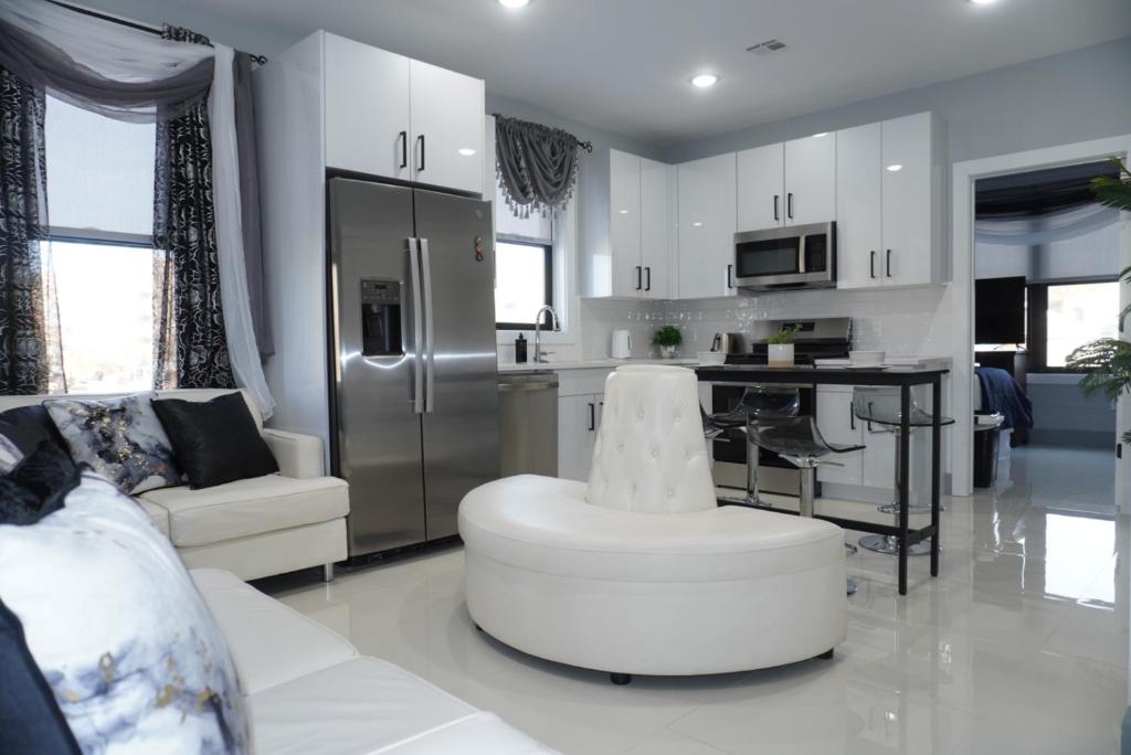 a living room with a couch and a kitchen at Big apple room 33 in West New York