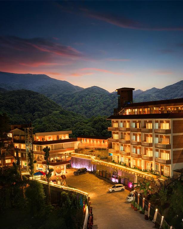a view of a building with mountains in the background at Nagarjun Resort - Embrace Tranquility Natures Retreat Beyond the City in Kathmandu