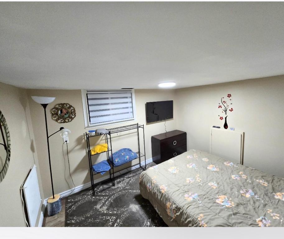 a bedroom with a bed and a tv in it at Bright Room in Walkout Basement in Pickering