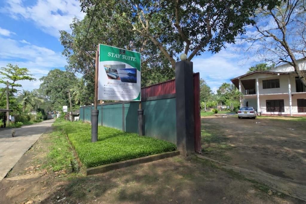 a street sign in front of a fence at Stay Suite in Mahiyangana