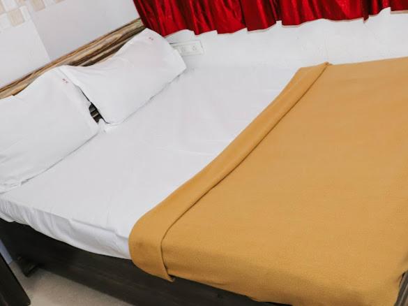 a close up of a bed in a room at Shree Residency in Airoli