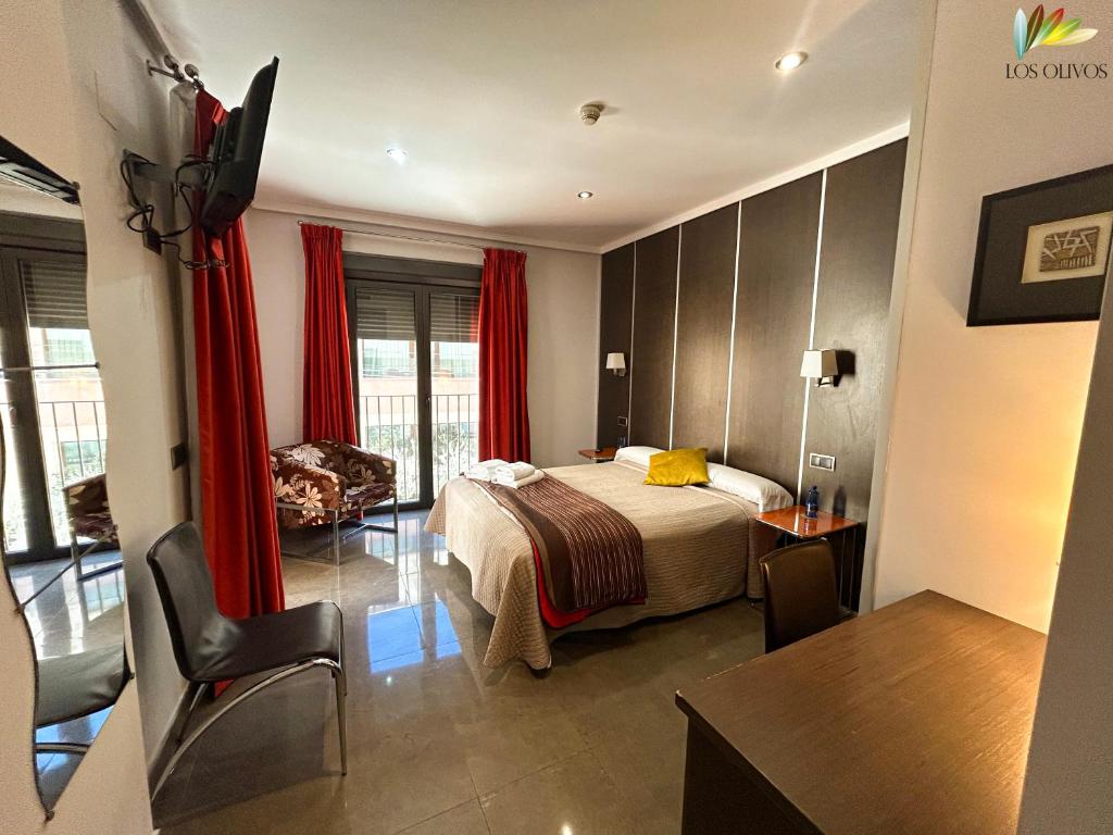 a hotel room with a bed and a desk at HS Alcalá in Alcalá del Júcar