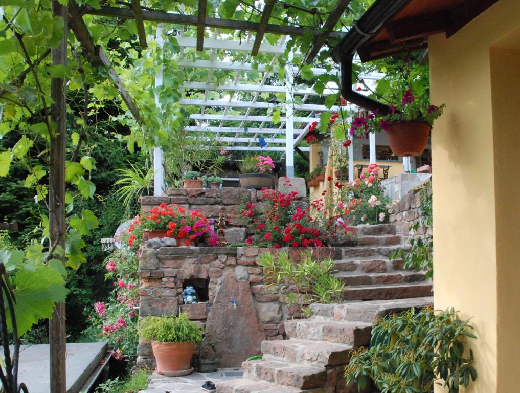 einen Garten mit Blumen und einem Steinkamin in der Unterkunft Am Berggarten in Heidelberg