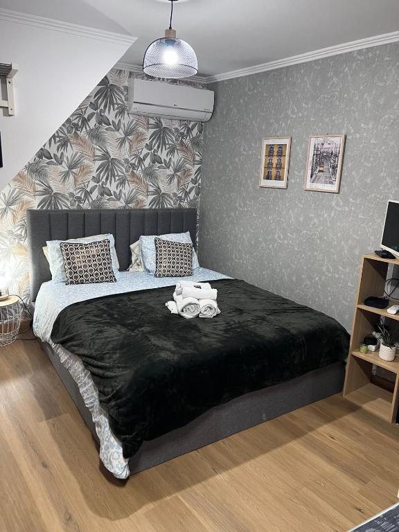 a bedroom with a large bed with a black blanket at coração alfama in Lisbon