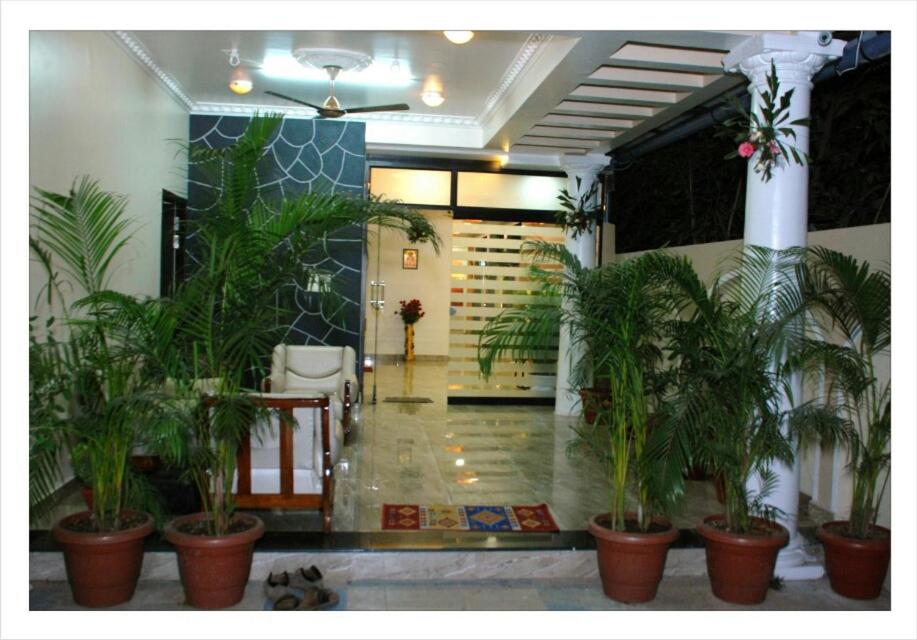 a lobby with a bunch of plants in pots at Matoshri Homestay Airport Road in Nagpur