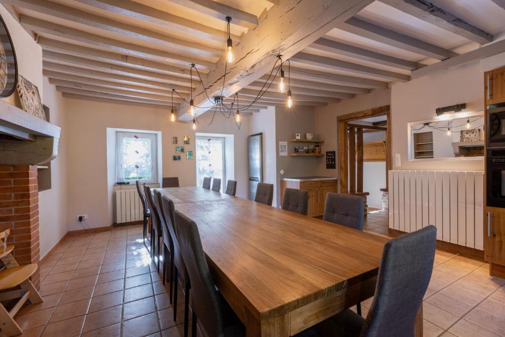 a dining room with a large wooden table and chairs at Montauvert in Montel-de-Gelat